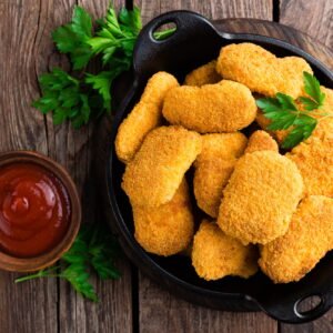 Nuggets. Chicken nuggets with ketchup on wooden table. Fast food